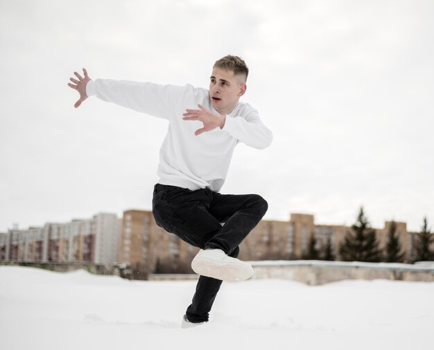 Vue latérale de l'artiste hip hop posant en dansant