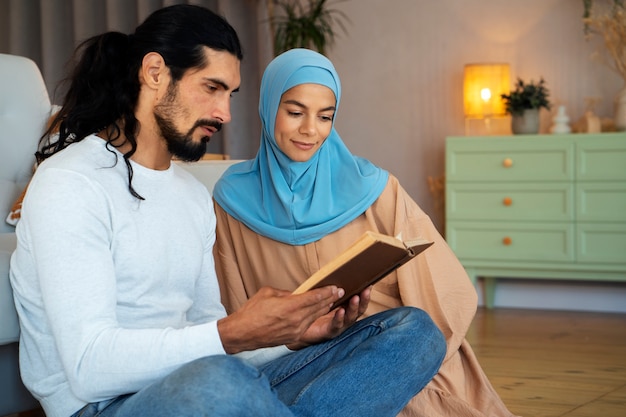 Photo gratuite vue latérale couple lisant un livre ensemble