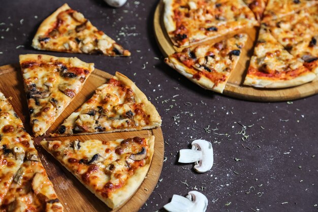 Vue latérale du mélange à pizza sur des plateaux avec des champignons et des épices