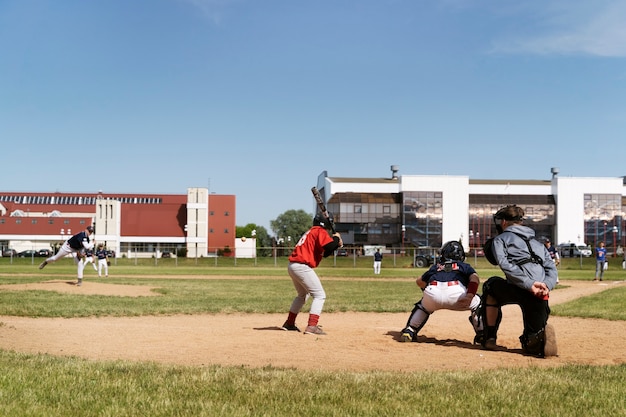 Vue latérale des enfants jouant au kickball à l'extérieur