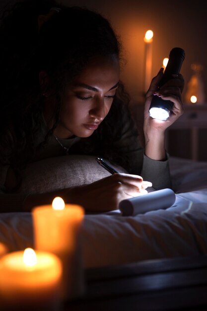 Vue latérale femme écrivant au lit