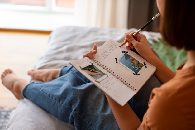 Photo gratuite vue latérale femme faisant un journal créatif