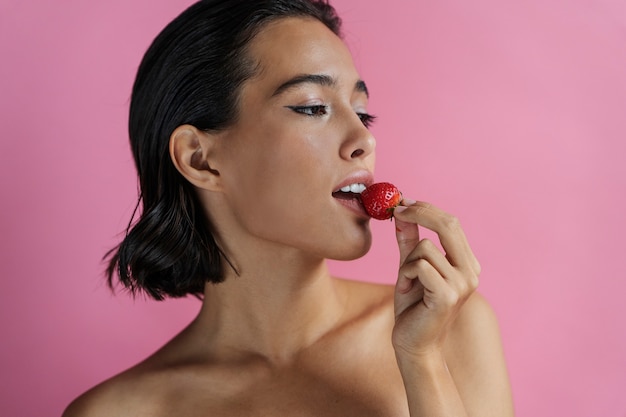 Photo gratuite vue latérale femme posant avec fraise