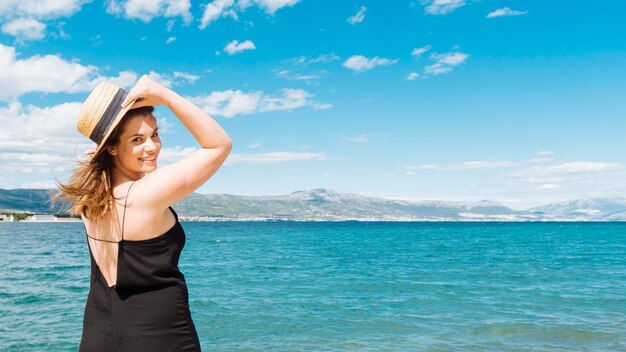 Vue latérale d'une femme posant sur l'océan