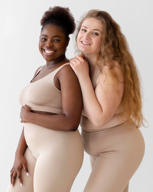 Vue latérale des femmes confiantes posant tout en portant un body shaper