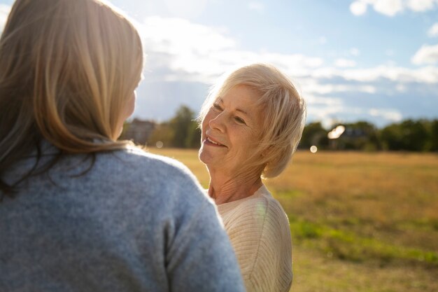 Vue latérale des femmes souriantes dans la nature
