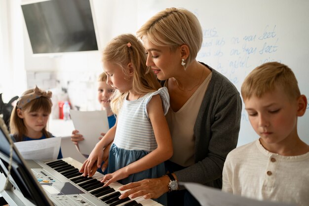 Vue latérale fille apprenant à jouer du piano