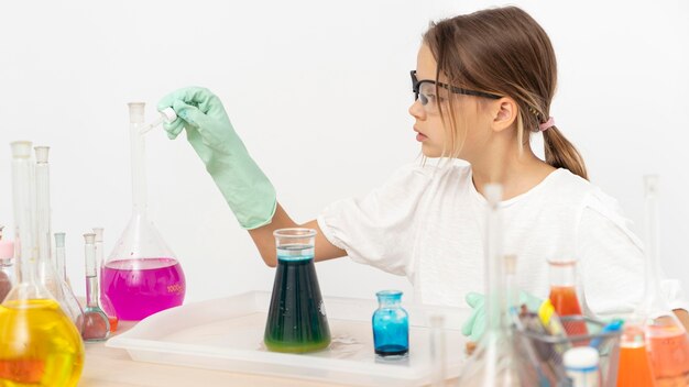 Vue latérale d'une fille faisant des expériences de chimie