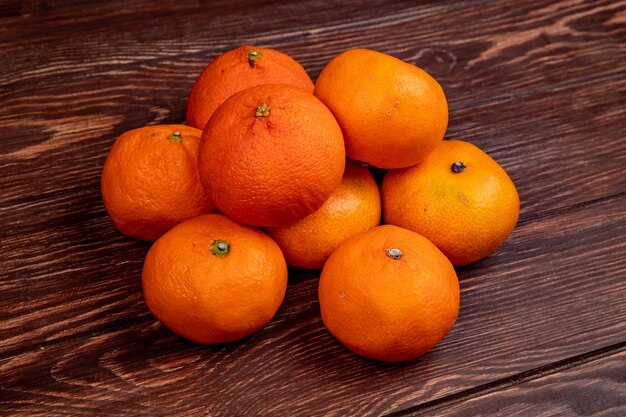 Vue latérale des mandarines mûres fraîches isolées sur bois rustique