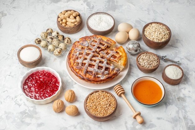 Vue rapprochée avant d'une délicieuse tarte à la confiture sur une farine d'oeufs de miel de noisettes blanches sucre sur une table de glace