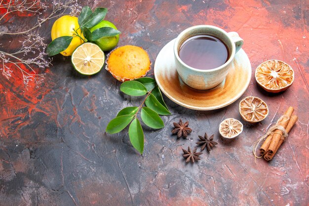 Vue rapprochée latérale une tasse de crème de thé tasse de thé noir citron anis étoilé cupcake cannelle