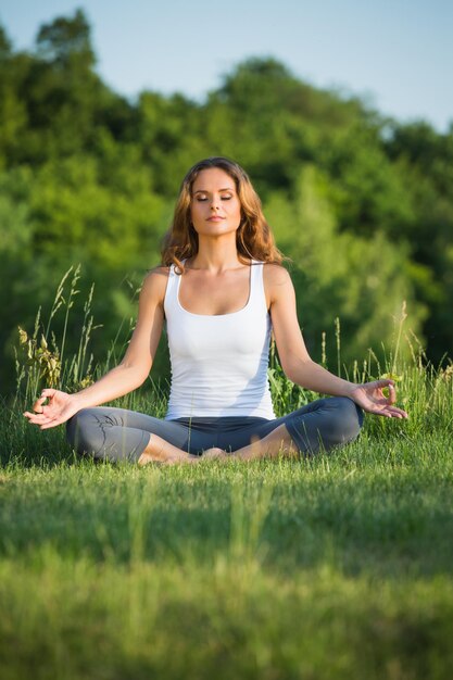 Yogi fille méditant avec la nature. Fille en posture de lotus pensant au bel esprit.
