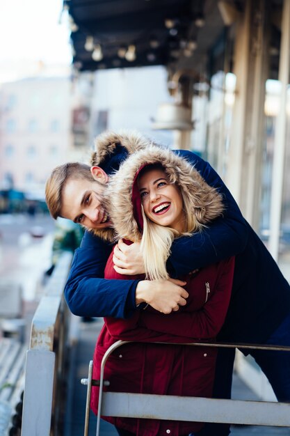 Young smiling happy European couple hugging in winter