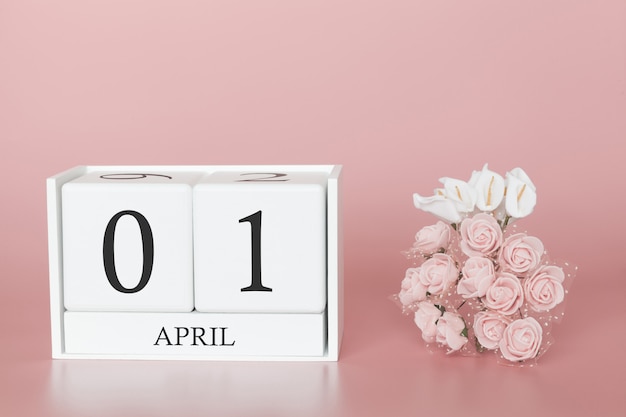 Photo 01 avril. jour 1 du mois. cube de calendrier sur rose moderne