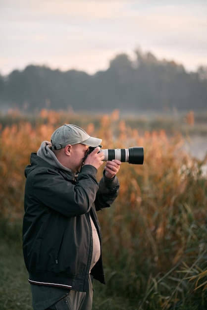 08102022 Gdansk Pologne Homme prenant une photo de la faune avec un appareil photo reflex numérique