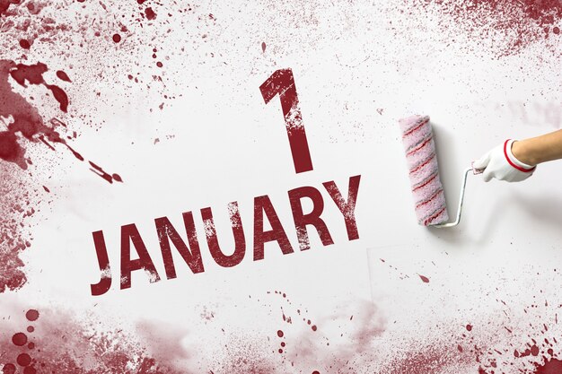 1er janvier Jour 1 du mois Date du calendrier La main tient un rouleau avec de la peinture rouge et écrit