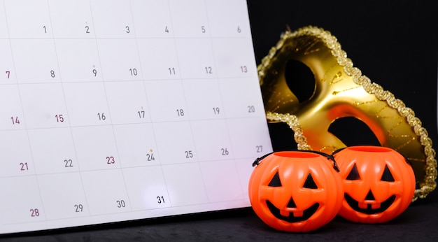 31 octobre sur calendrier avec fantaisie mystère masque doré &amp; effrayant citrouille