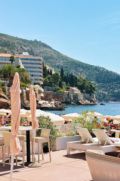 Abris et plage de la mer Adriatique, Dubrovnik, Croatie. Les gens en arrière-plan