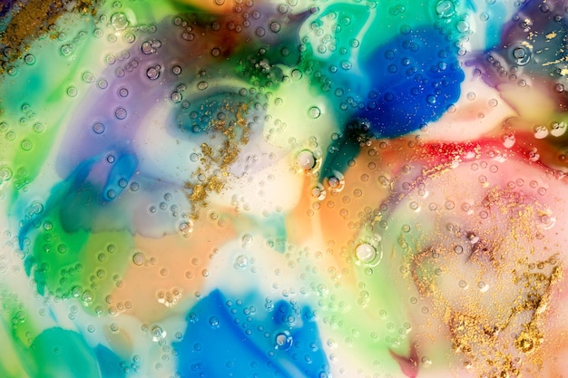 Photo abstrait aquarelle coloré. verre liquide avec bulles et poussière d'or.