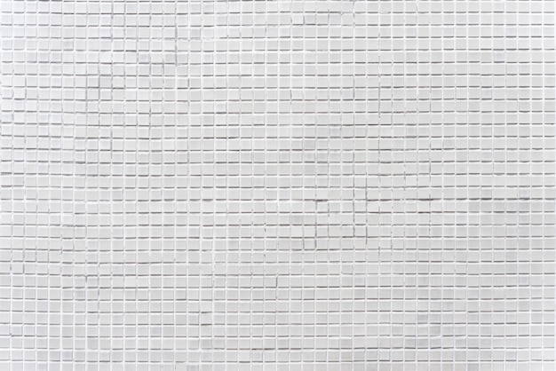 Photo abstrait de carreaux de mosaïque de briques grises décorées sur le mur.