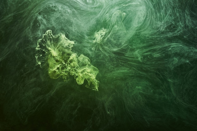 Abstrait de couleur verte. Fumée de narguilé vibrante tourbillonnante, océan émeraude sous-marin, peinture dynamique dans l'eau