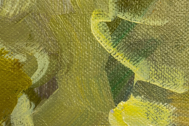 Abstrait avec peinture à l'huile verte et jaune sur toile. Gros plan des coups de pinceau dans la peinture. Peinture vert olive et jaune citron. Conception de fond à la main avec texture de toile. Peinture à l'huile