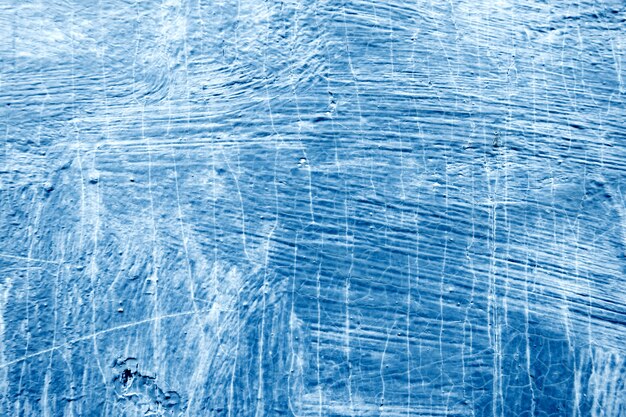 Photo abstrait avec des traits texturés de peinture bleue sur la surface en bois