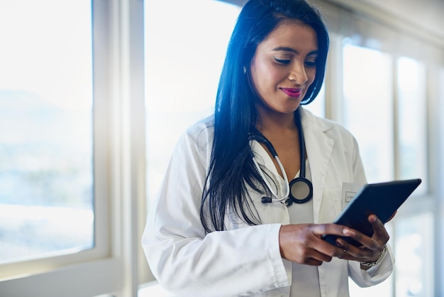 Accéder à tous les dossiers de ses patients sur un seul appareil pratique Photo d'une femme médecin utilisant une tablette numérique dans un hôpital