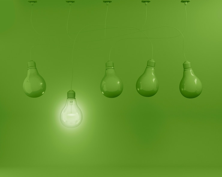 Photo accrocher des ampoules vertes avec une idée différente sur fond vert. con minimal