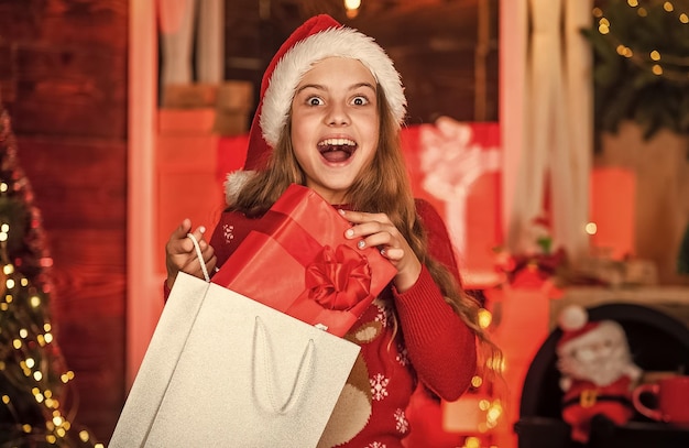 Achats à domicile Petite fille avec des sacs à provisions Concept de centre commercial Enfant excité Ventes et remises Petite fille avec des cadeaux Achats d'hiver Vente de Noël Économie d'achat de vacances Acheter un décor