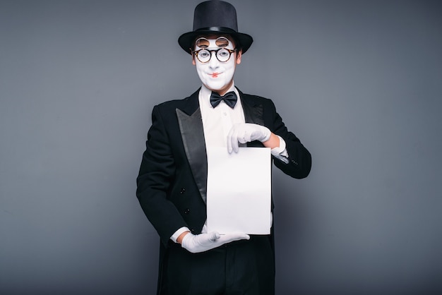 Acteur de mime masculin avec feuille de papier vide