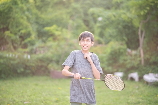 Photo adolescent garçon jouant au badminton parc extérieur extérieur