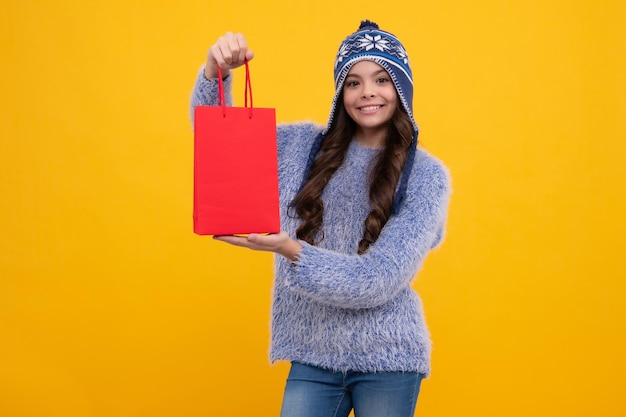 Adolescente élégante en chapeau chaud d'automne avec des sacs de vente
