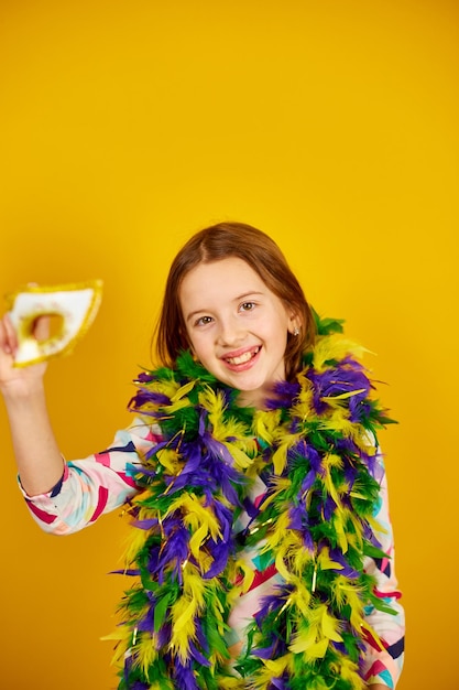 Une adolescente joyeuse portant un masque de carnaval brésilien coloré