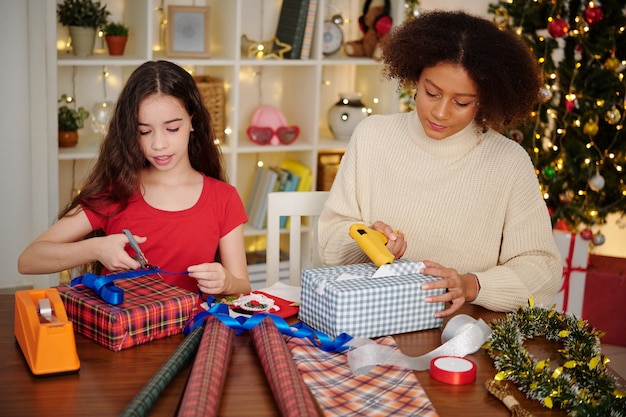 Adolescentes emballant des cadeaux pour la célébration de Noël à la maison