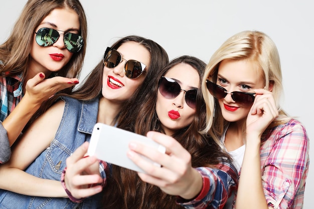 Adolescentes heureuses avec smartphone prenant selfie
