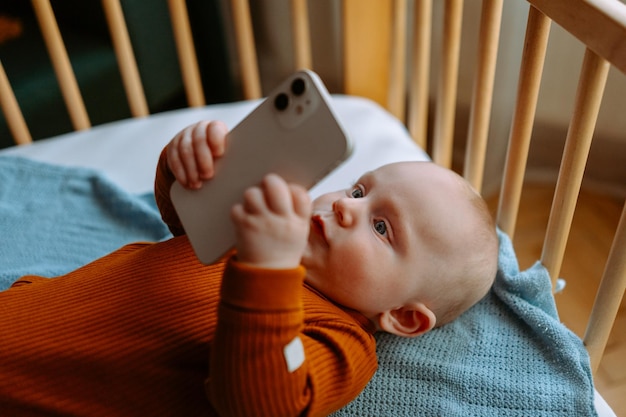 Adorable bambin bébé garçon regardant l'histoire de bébé au téléphone