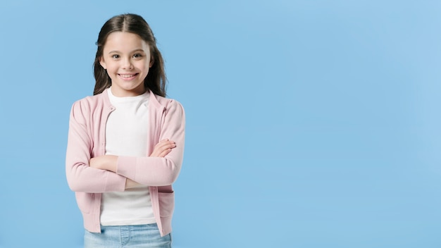 Adorable fille debout en studio et souriant