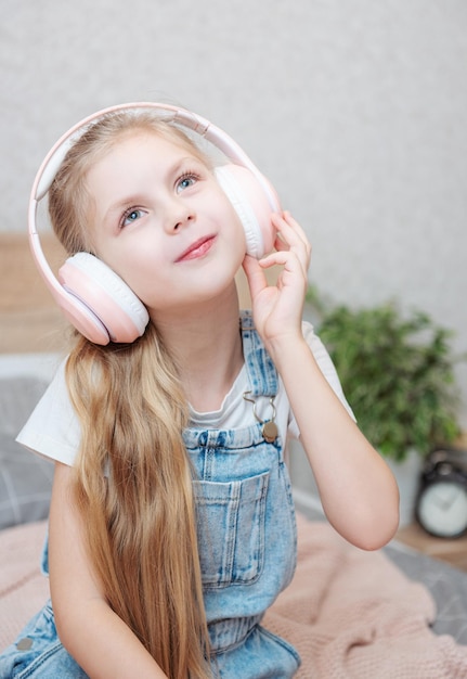 Adorable petite fille au casque profiter d'une musique