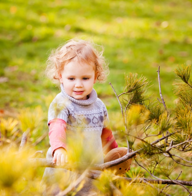 Adorable petite fille aux feuilles d'automne