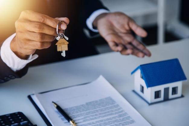 Agent de courtage immobilier présentant et consultant le client pour la prise de décision signant un contrat d'assurance modèle d'achat et de vente de maison concernant l'offre de prêt hypothécaire et l'assurance habitation