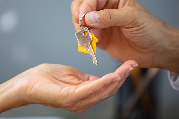 Agent immobilier donnant la clé de la maison à une femme