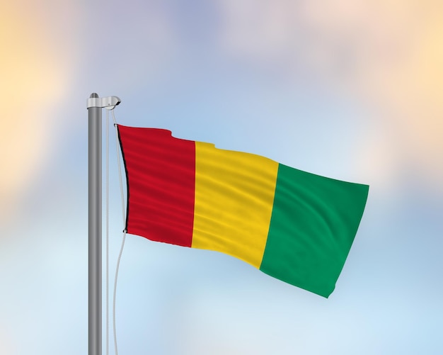 Agitant le drapeau de la Guinée sur un mât