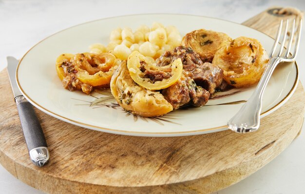 Agneau au citron, artichauts et tiges de coriandre frit à feu doux.