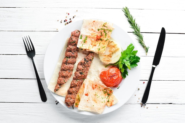 Agneau Kebab Lavash et épices Sur un fond en bois blanc Vue de dessus