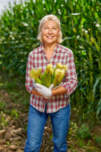 Agriculteur heureux avec une récolte de maïs.