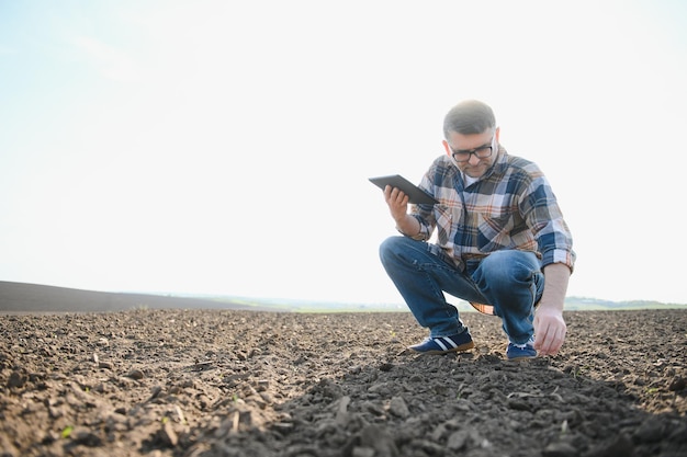 Un agriculteur vérifie la qualité du sol avant de semer