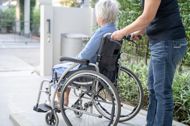 Aide et soins aux soignants Asiatique senior ou âgée vieille dame patiente assise sur un fauteuil roulant à l'hôpital de soins infirmiers sain concept médical fort