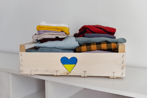 Aidez le concept de don de bénévolat boîte de dons pleine de vêtements à la maison