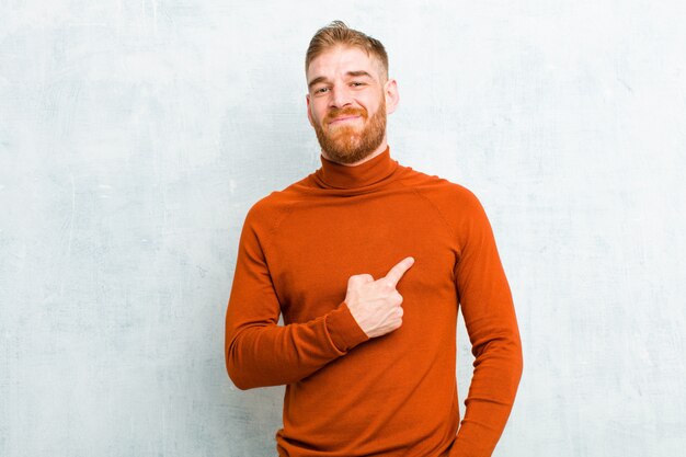 air fier, confiant et heureux, souriant et se montrant soi-même ou faisant le signe numéro un